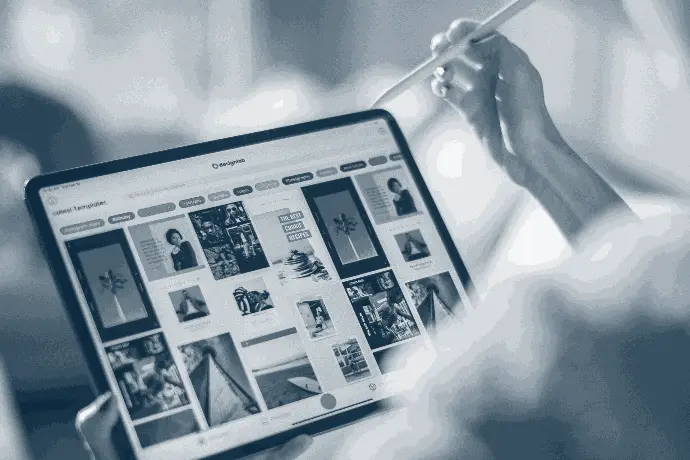 A person using a tablet and pen, showcasing mobile solutions in the leisure industry.